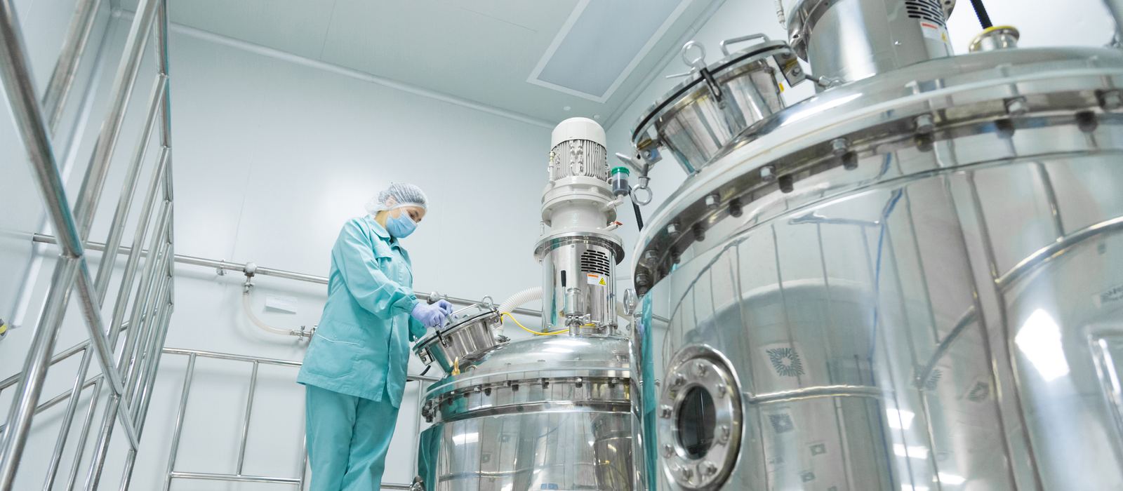 Process engineer at a stainless steel reactor in a pharma clean room