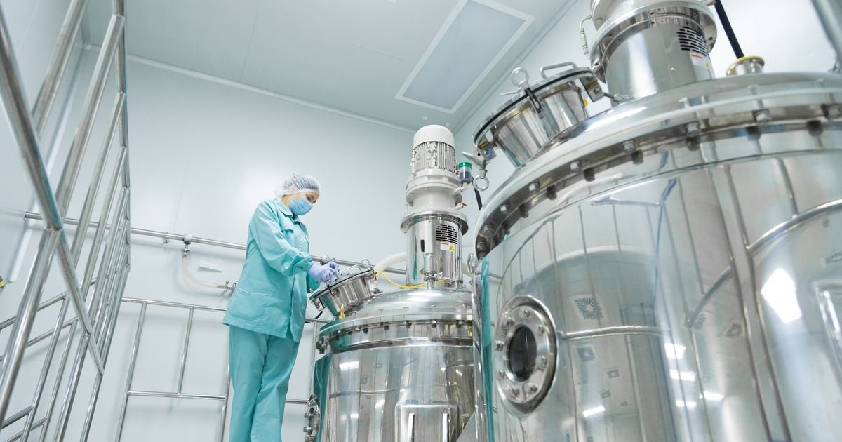 Pharmaceutical process reactor in a clean processing area, the kind of room a GMP layout has to zone and grade