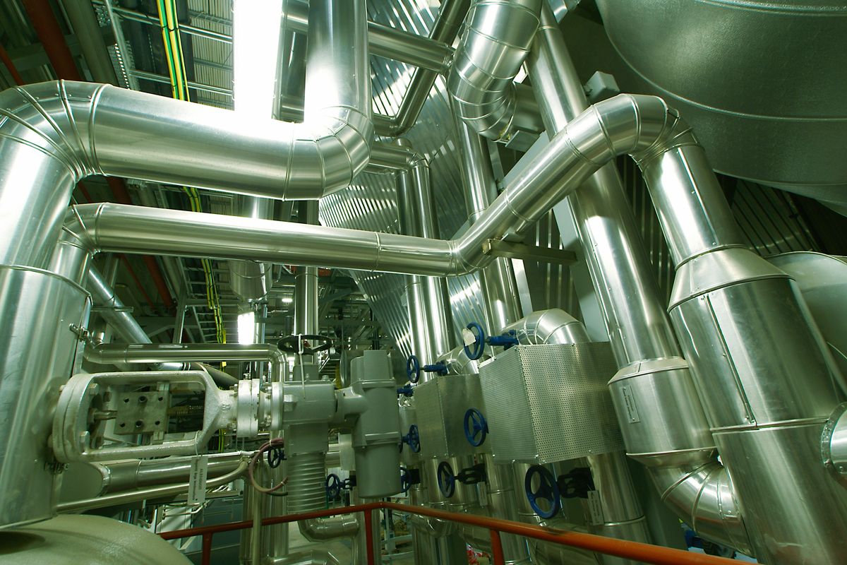 Insulated process pipework and valve stations inside an operating plant