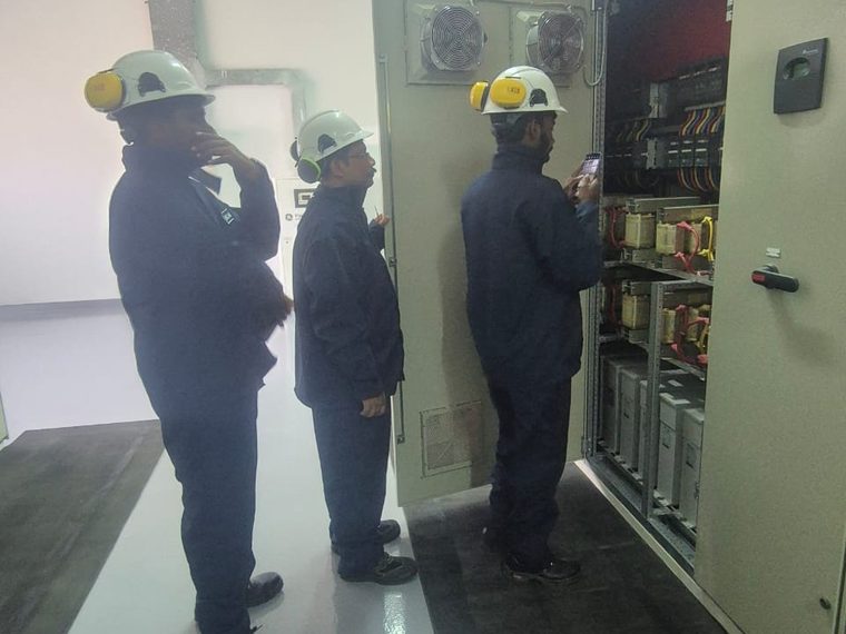 Open switchgear cubicle showing internal busbars and protective devices during verification of the as-installed configuration